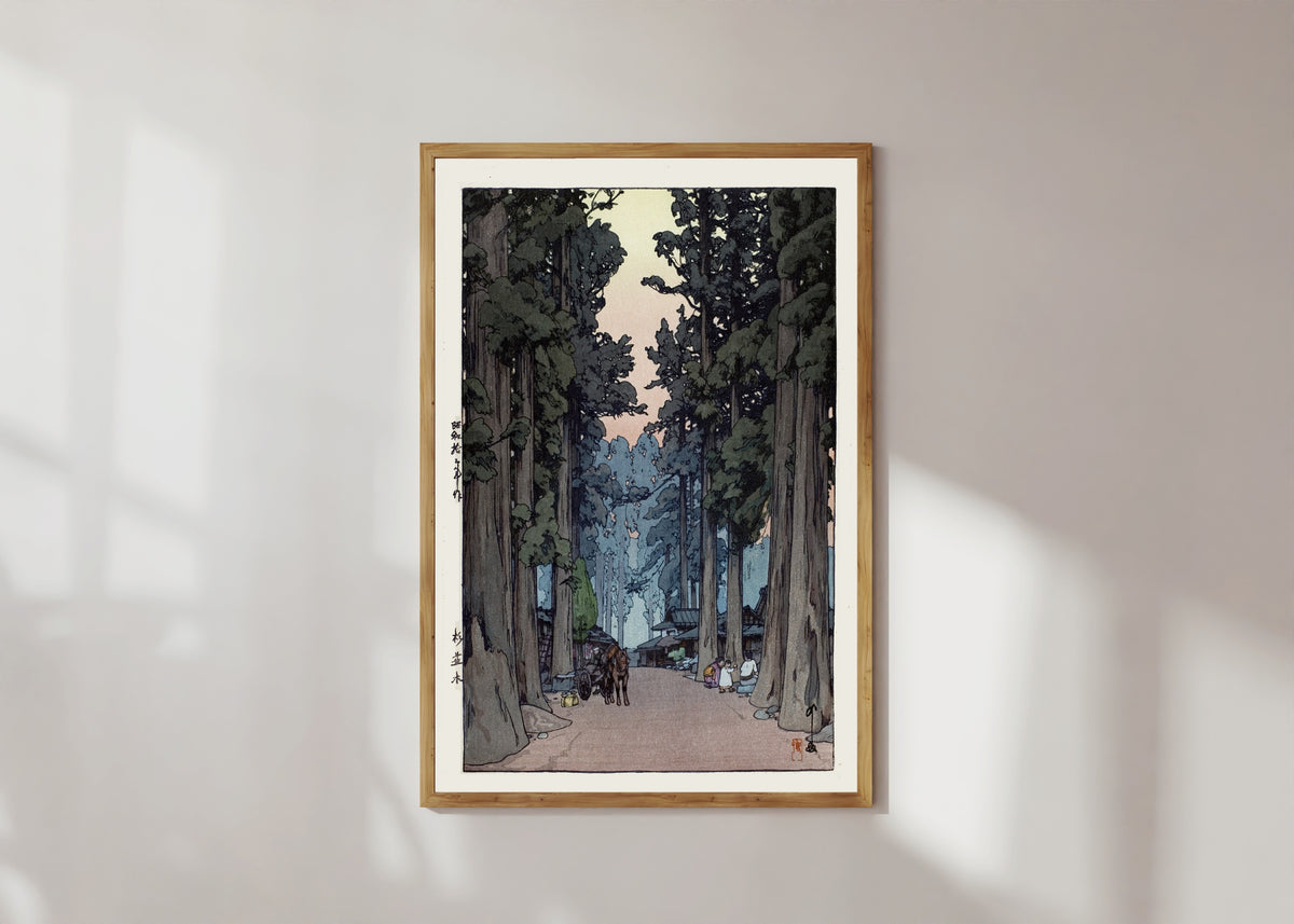 Framed art print of Cryptomeria Avenue by Hiroshi Yoshida, in a light wood frame on a sunlit white wall