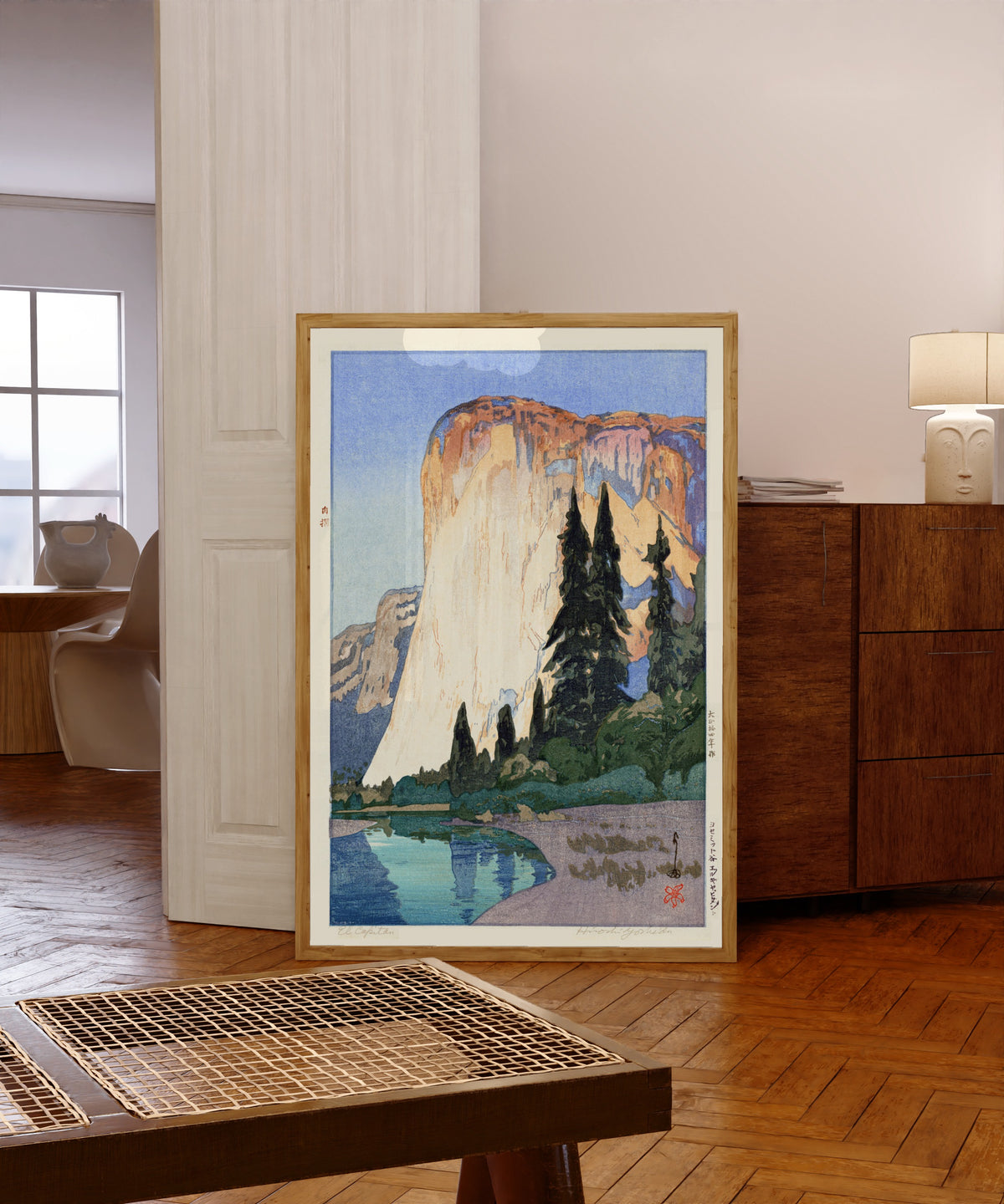 Framed art print of El Capitan by Hiroshi Yoshida, in a light wood frame leaning in a warm room with a parquet floor