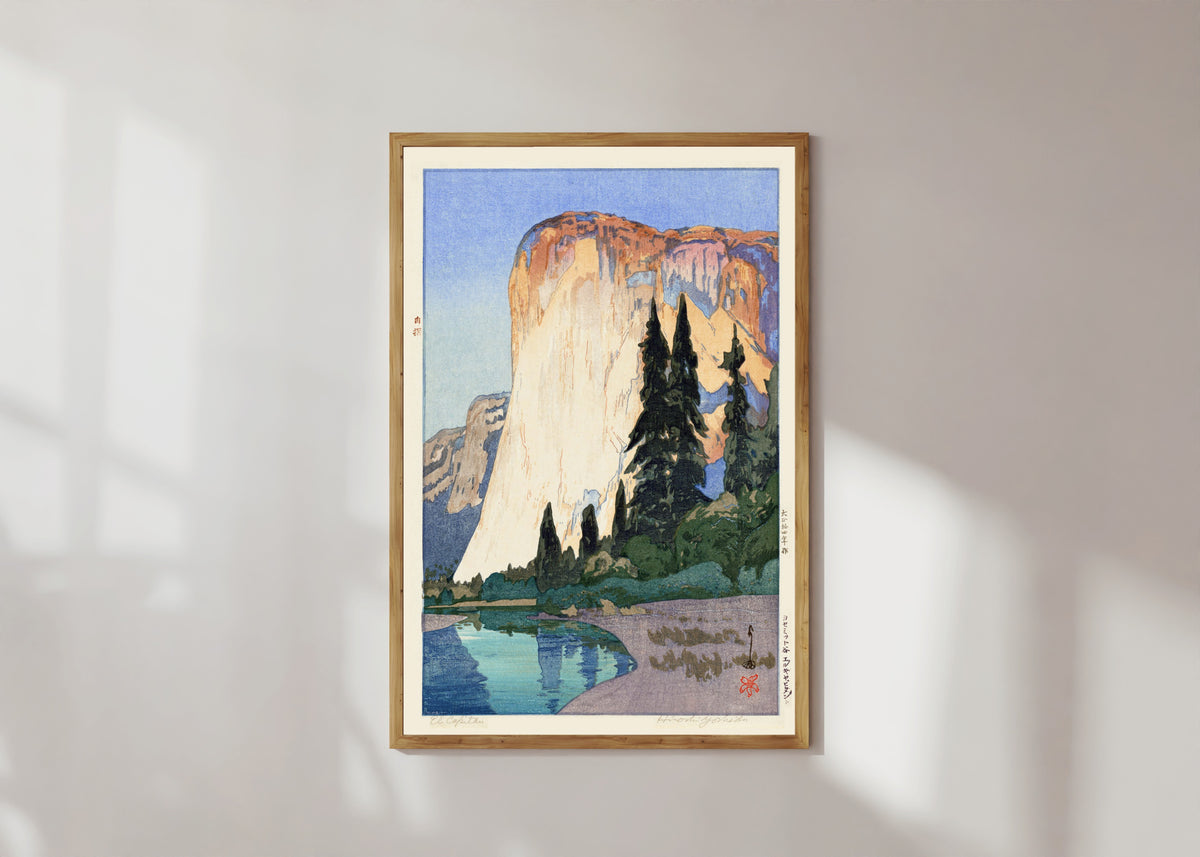 Framed art print of El Capitan by Hiroshi Yoshida, in a light wood frame on a sunlit white wall