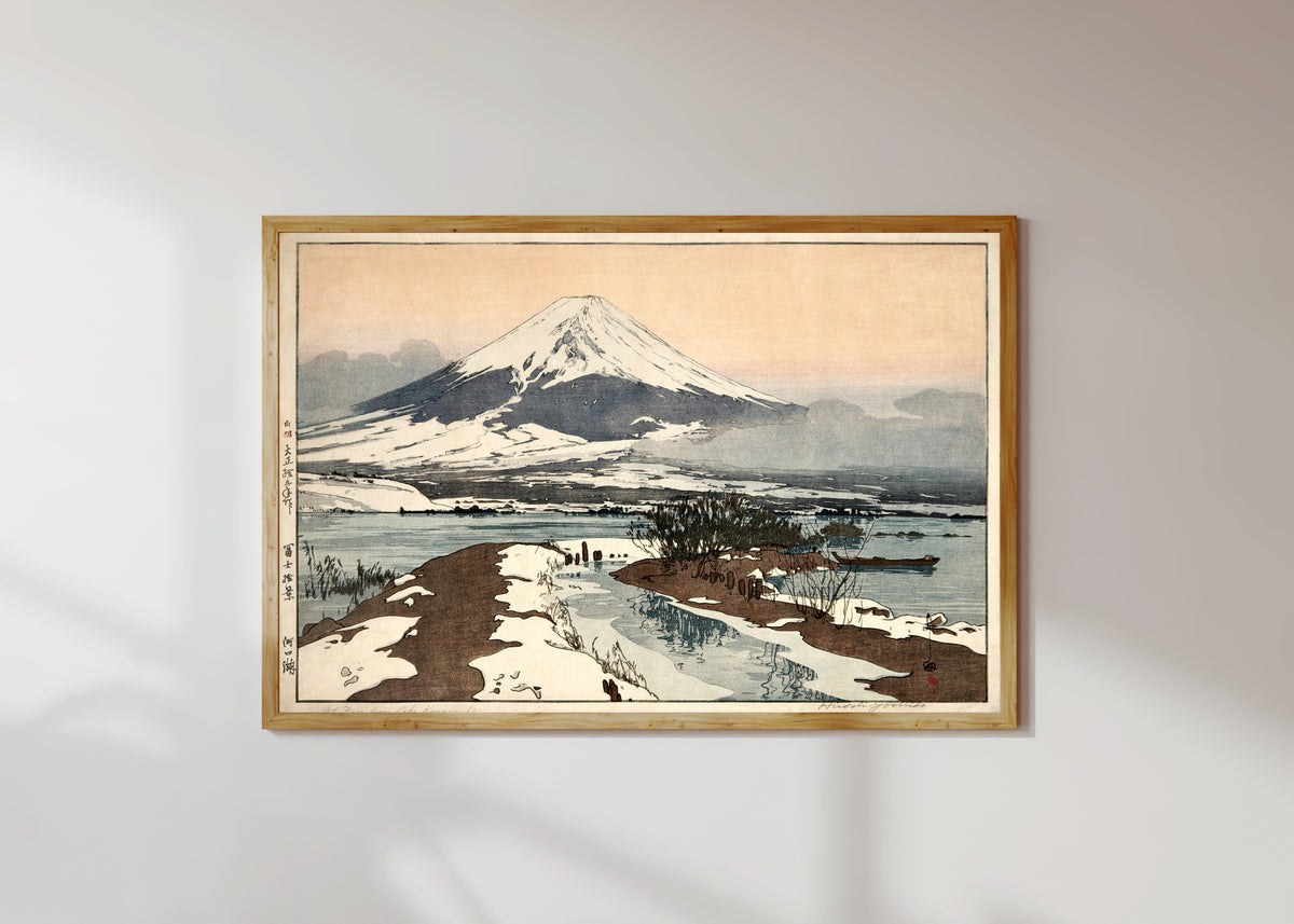 Framed art print of Fuji from Lake Kawaguchi by Hiroshi Yoshida, in a light wood frame on a sunlit white wall
