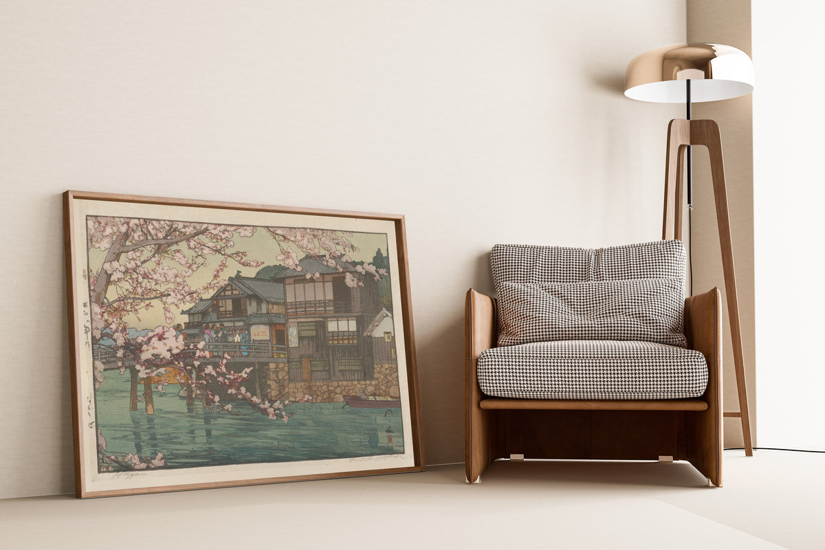 Framed art print of Hayase by Hiroshi Yoshida, leaning against a wall beside an armchair and a floor lamp