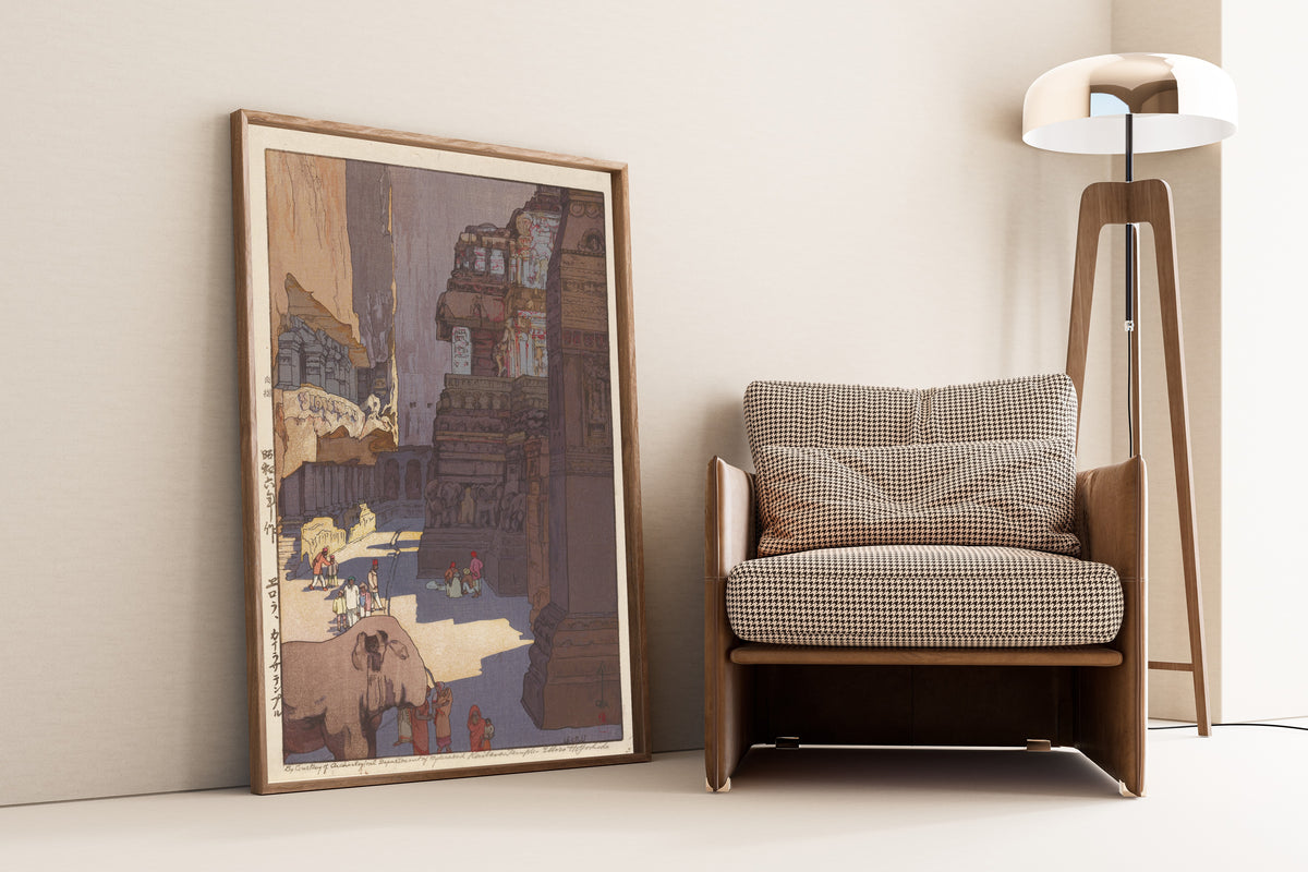 Framed art print of Kailasa Temple at Ellora by Hiroshi Yoshida, leaning against a wall beside an armchair and a floor lamp