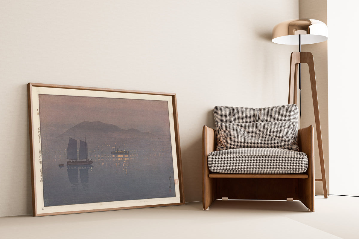 Framed art print of Kōnoshima by Hiroshi Yoshida, leaning against a wall beside an armchair and a floor lamp