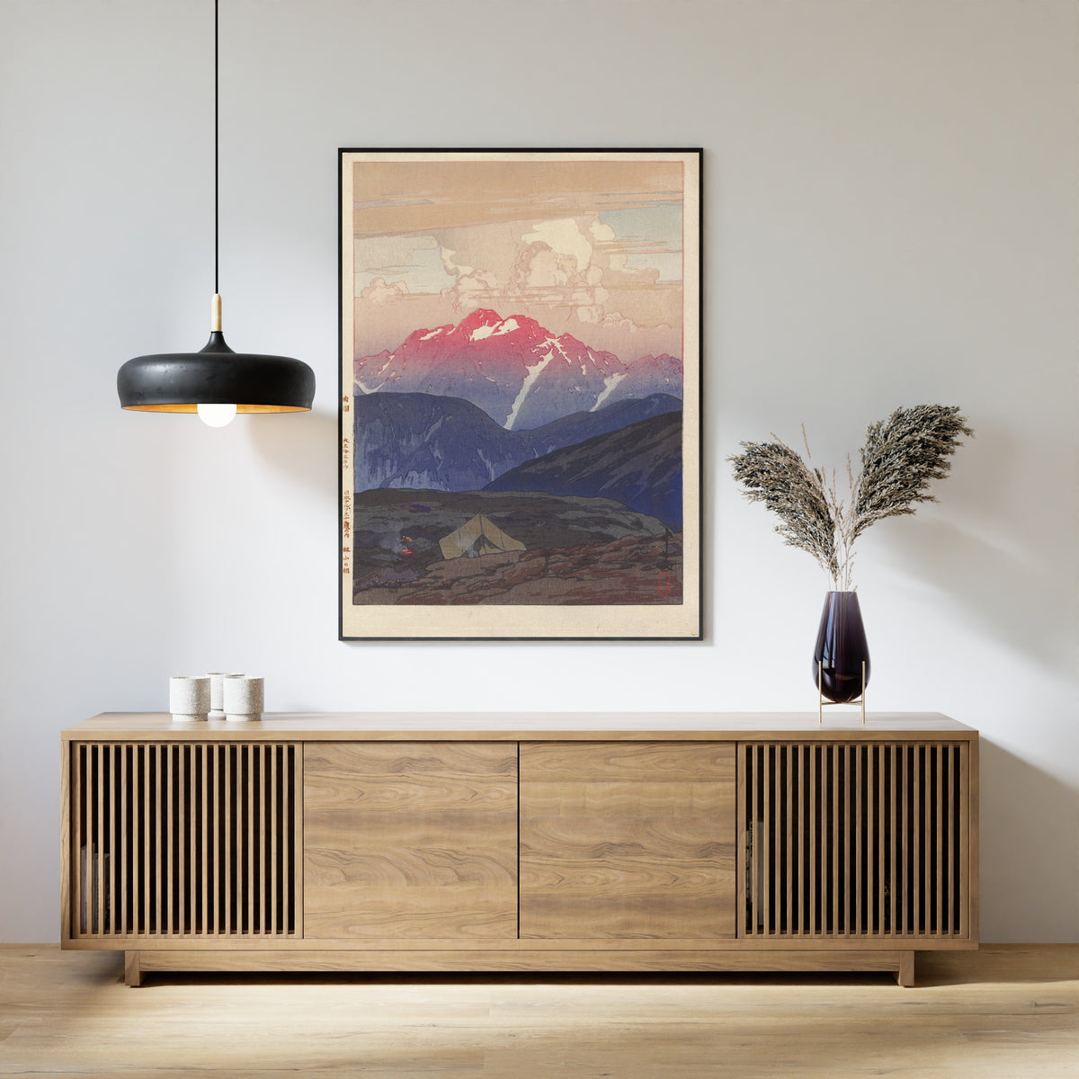 Framed art print of Morning at Mount Tsurugi by Hiroshi Yoshida, above a slatted wood sideboard
