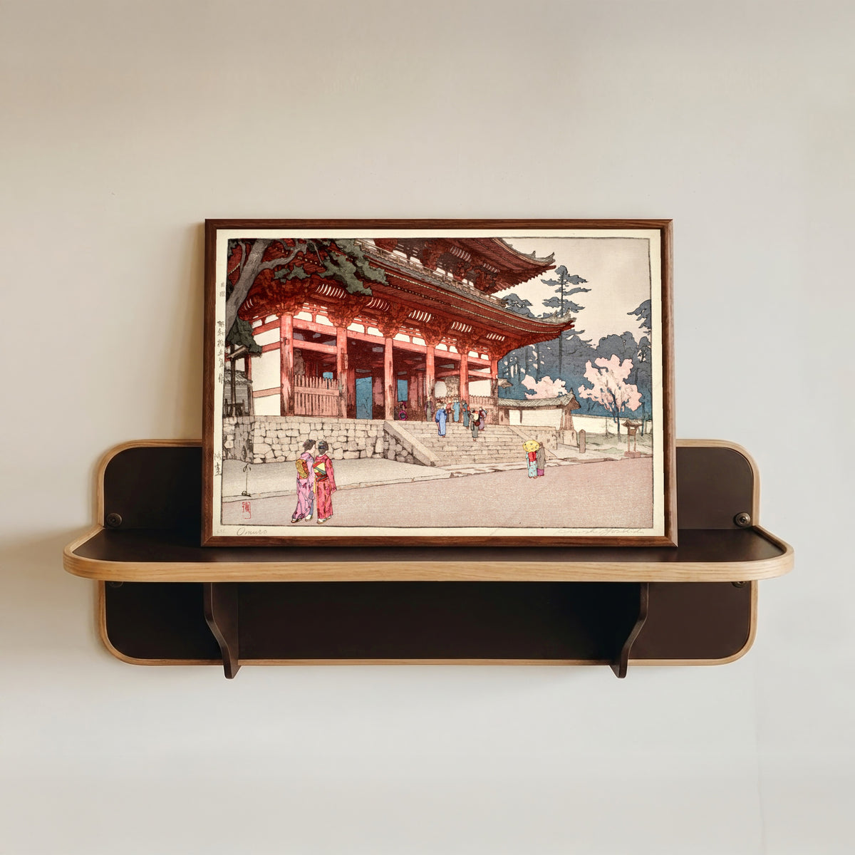 Framed art print of Omuro by Hiroshi Yoshida, in a dark wood frame resting on a wall shelf