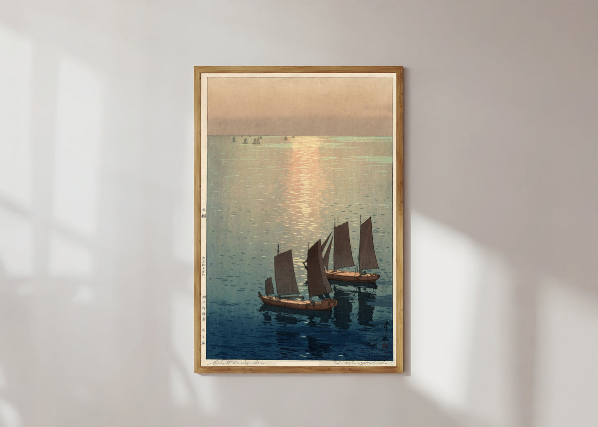 Framed art print of Afternoon Sailboats by Hiroshi Yoshida, in a light wood frame on a sunlit white wall