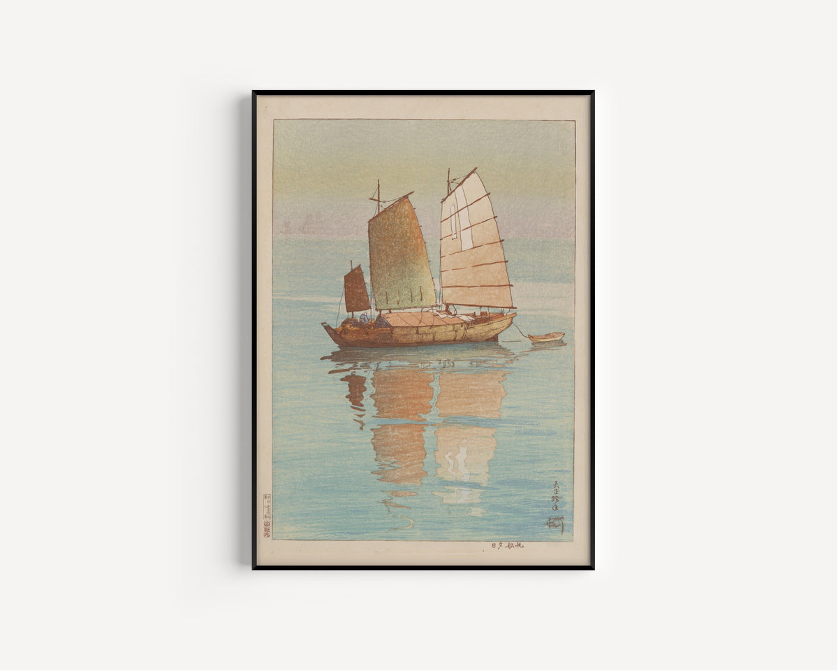 Framed art print of Sailing Boats, Evening Glow by Hiroshi Yoshida, in a slim black frame on a plain white wall
