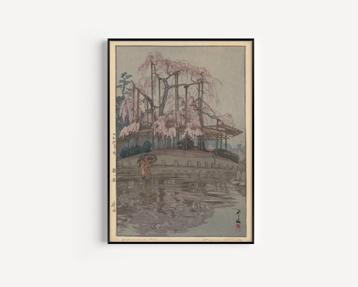Framed art print of Spring Rain, from Eight Scenes of Cherry Blossoms by Hiroshi Yoshida, in a slim black frame on a plain white wall
