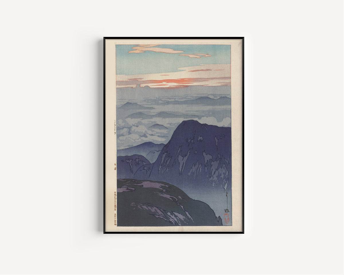 Framed art print of Sunrise on Eboshidake by Hiroshi Yoshida, in a slim black frame on a plain white wall