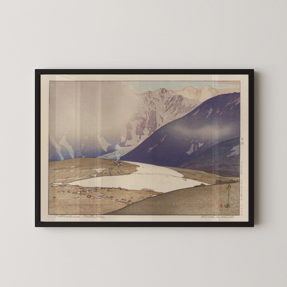 Framed art print of Tateyama Betsuzan by Hiroshi Yoshida, in a black frame on a pale wall