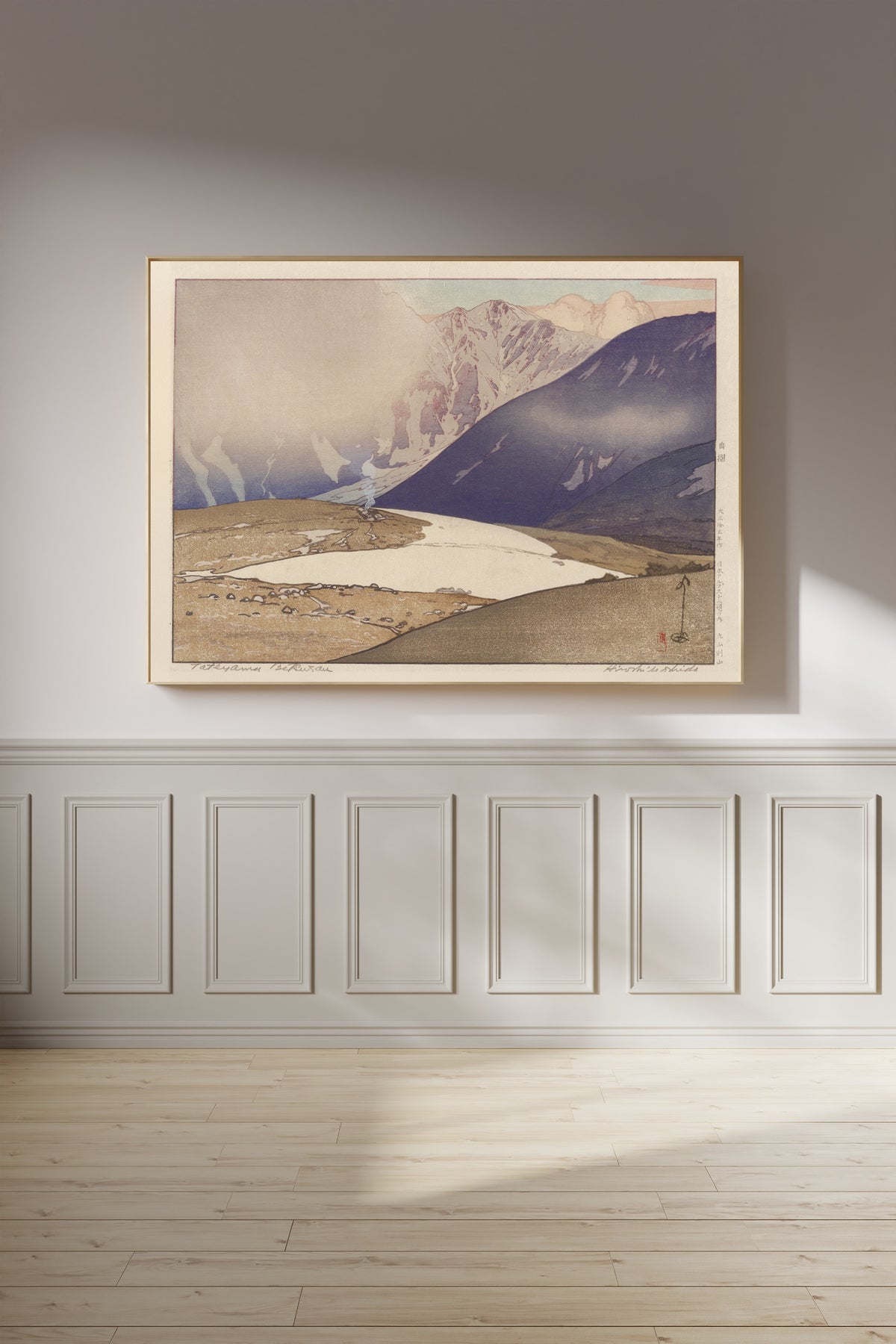 Framed art print of Tateyama Betsuzan by Hiroshi Yoshida, on a panelled wall in afternoon light