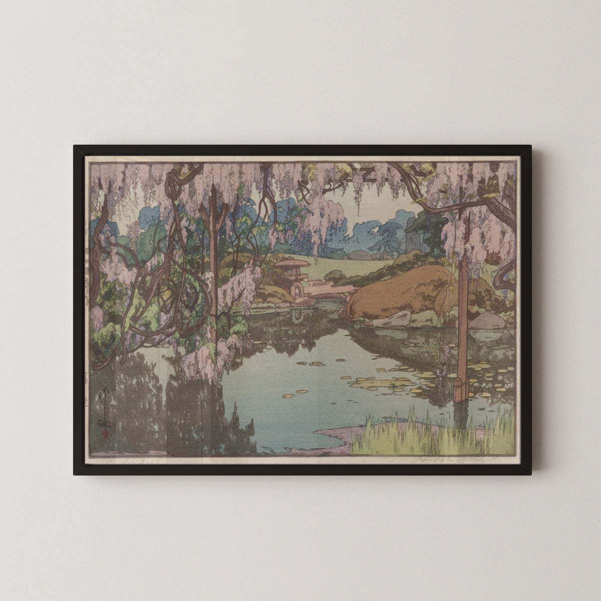 Framed art print of Wisteria Garden by Hiroshi Yoshida, in a black frame on a pale wall