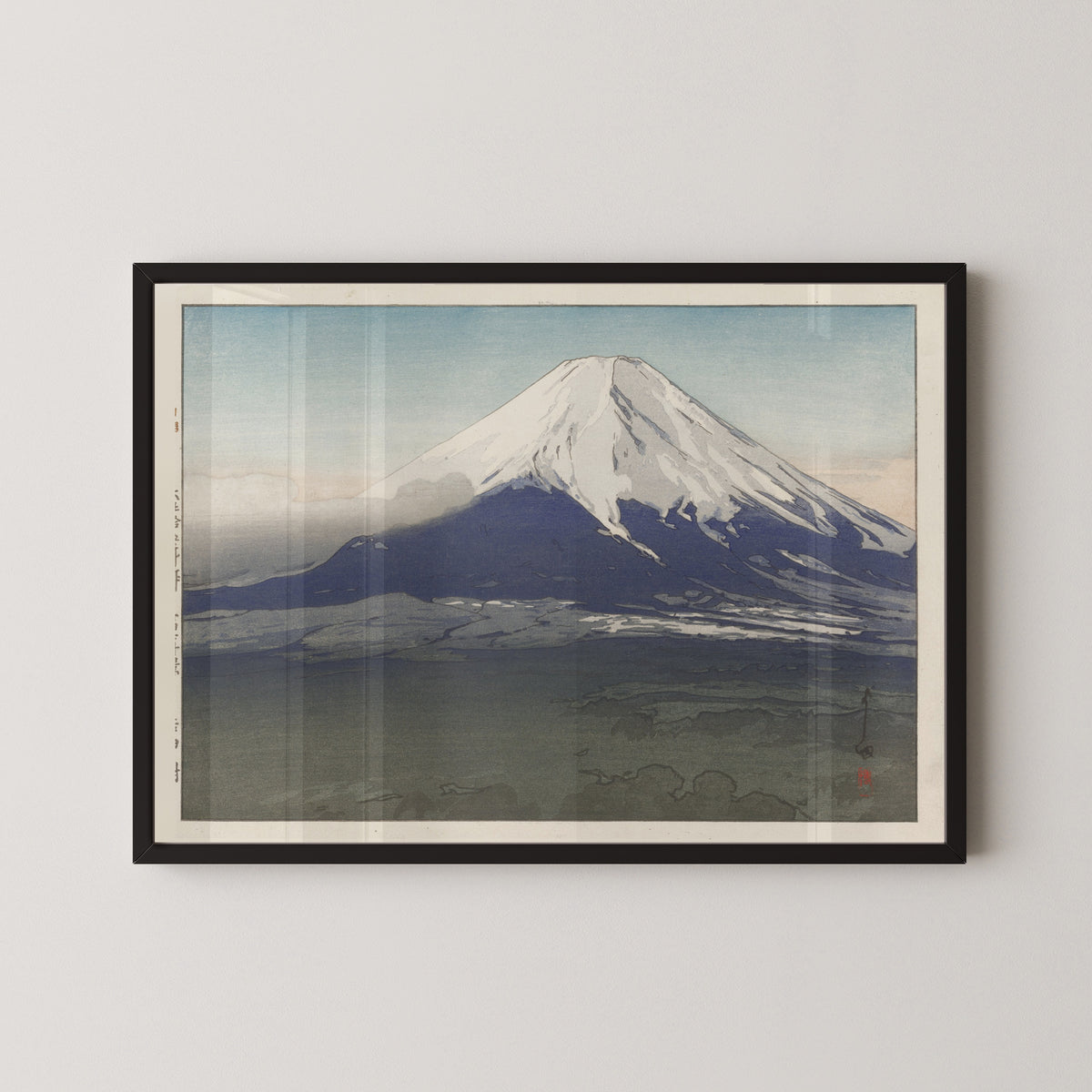 Framed art print of Yoshida Village by Hiroshi Yoshida, in a black frame on a pale wall