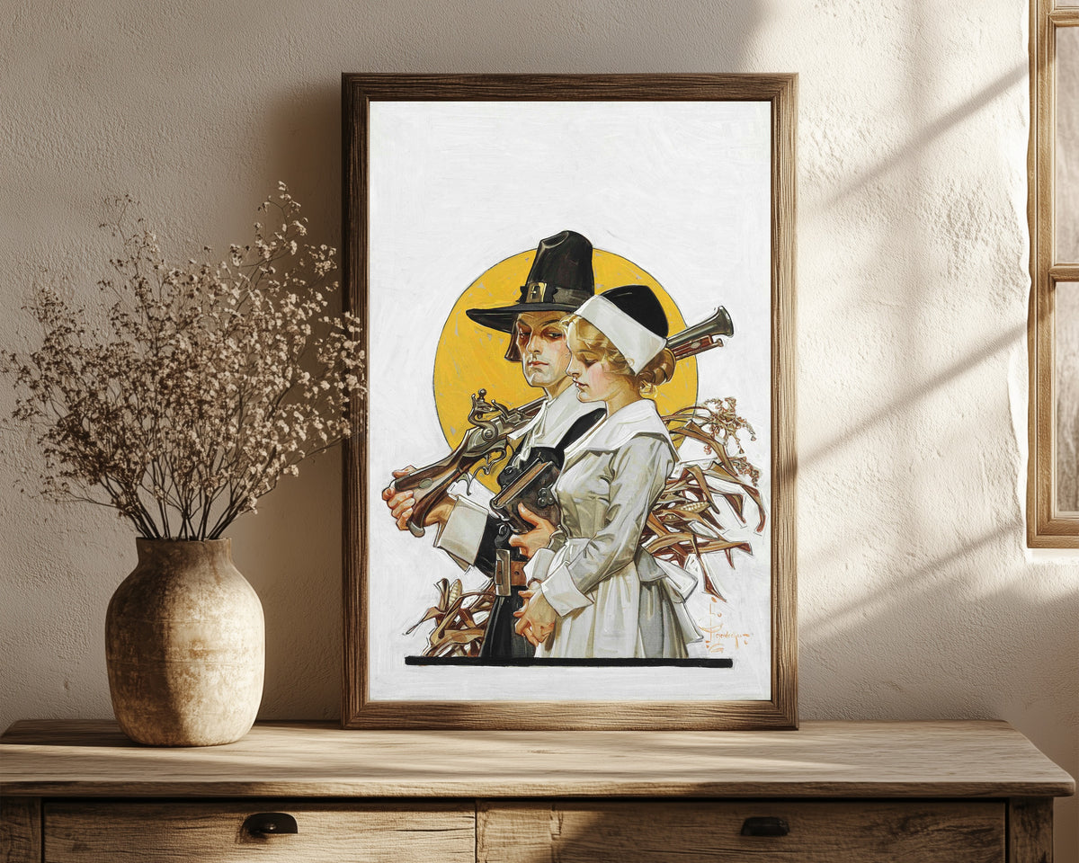 Framed art print of Giving Thanks (Thanksgiving Couple) by J.C. Leyendecker, in a dark wood frame leaning on a rustic console beside dried flowers