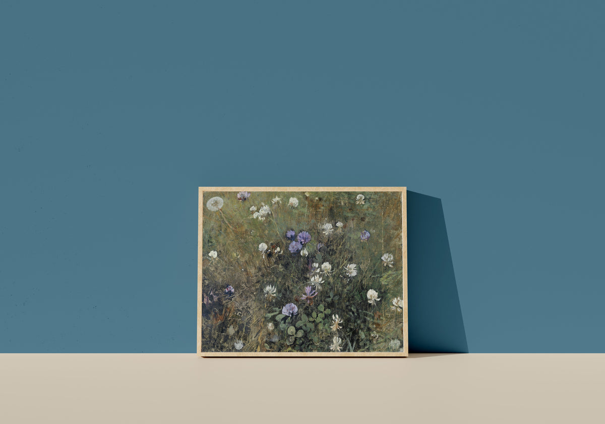Framed art print of Blooming Clover by Jac van Looij, in a light wood frame leaning on a blue wall