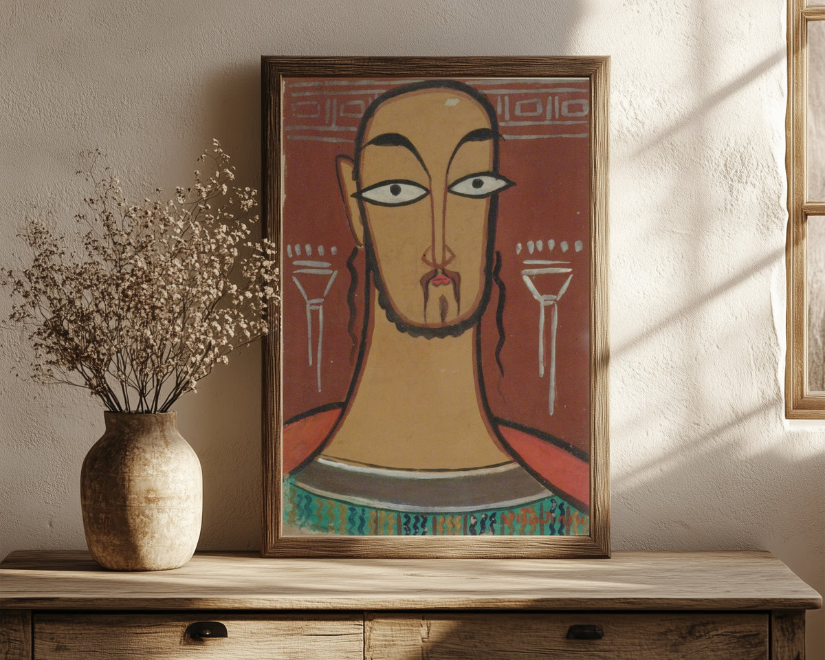 Framed art print of Christ (Jishu) by Jamini Roy, in a dark wood frame leaning on a rustic console beside dried flowers