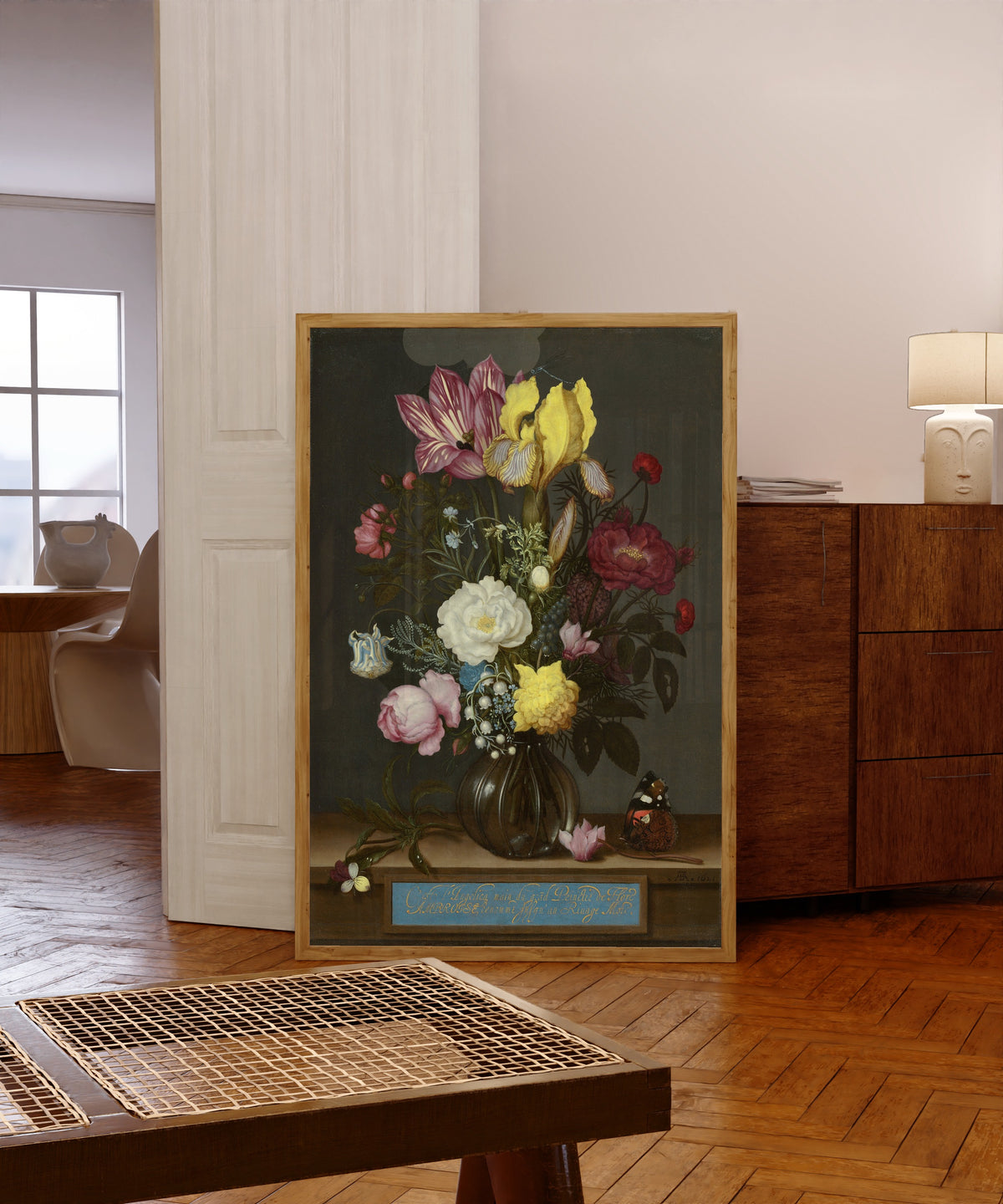 Framed art print of Bouquet of Flowers in a Glass Vase by Jan Davidsz. de Heem, in a light wood frame leaning in a warm room with a parquet floor