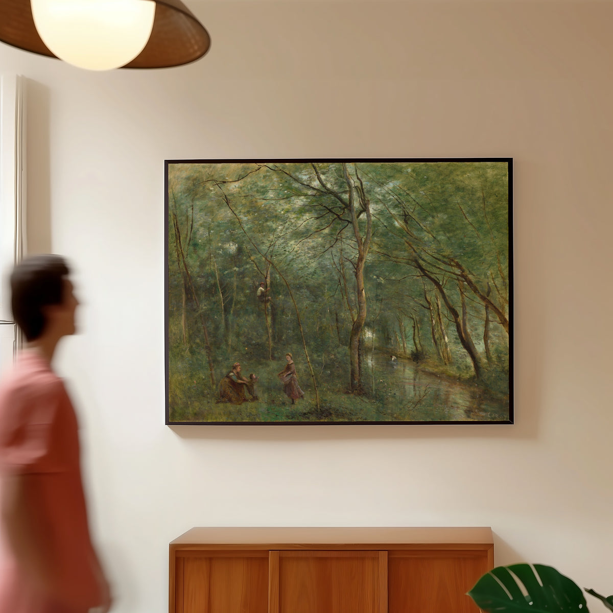 Framed art print of The Eel Gatherers by Jean-Baptiste-Camille Corot, in a slim black frame on a warm wall in a sunlit room