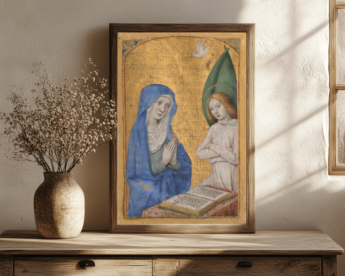 Framed art print of Book of Hours: The Annunciation by Jean Bourdichon, in a dark wood frame leaning on a rustic console beside dried flowers