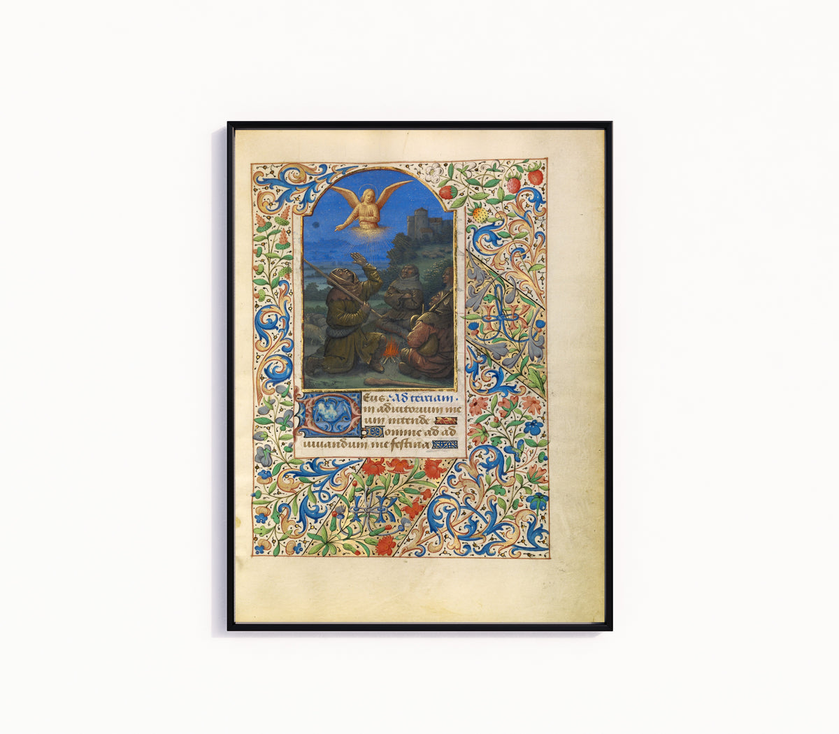 Framed art print of The Annunciation to the Shepherds by Jean Bourdichon, in a slim black frame on a plain white wall