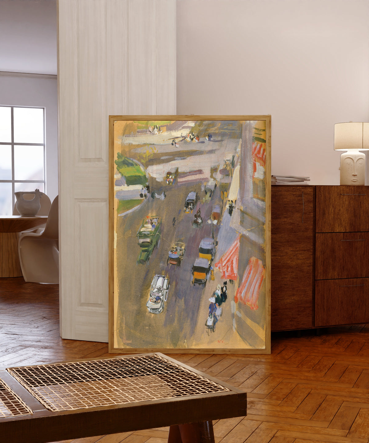 Framed art print of Fifth Avenue, New York by Joaquín Sorolla, in a light wood frame leaning in a warm room with a parquet floor