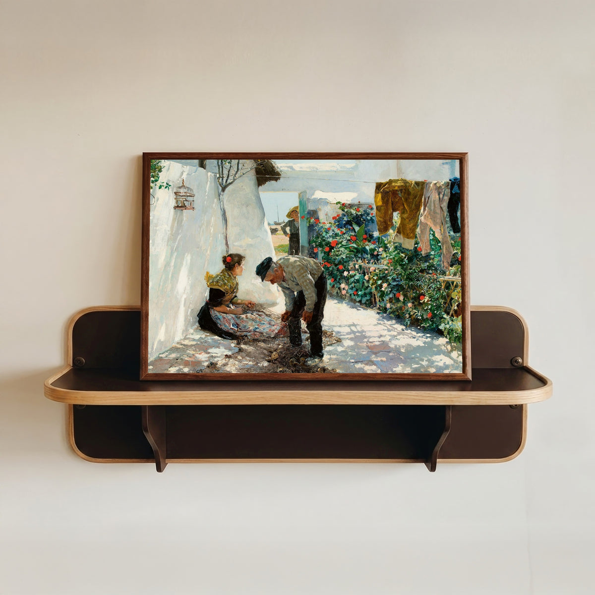Framed art print of Fishing Nets (Las redes) by Joaquín Sorolla, in a dark wood frame resting on a wall shelf