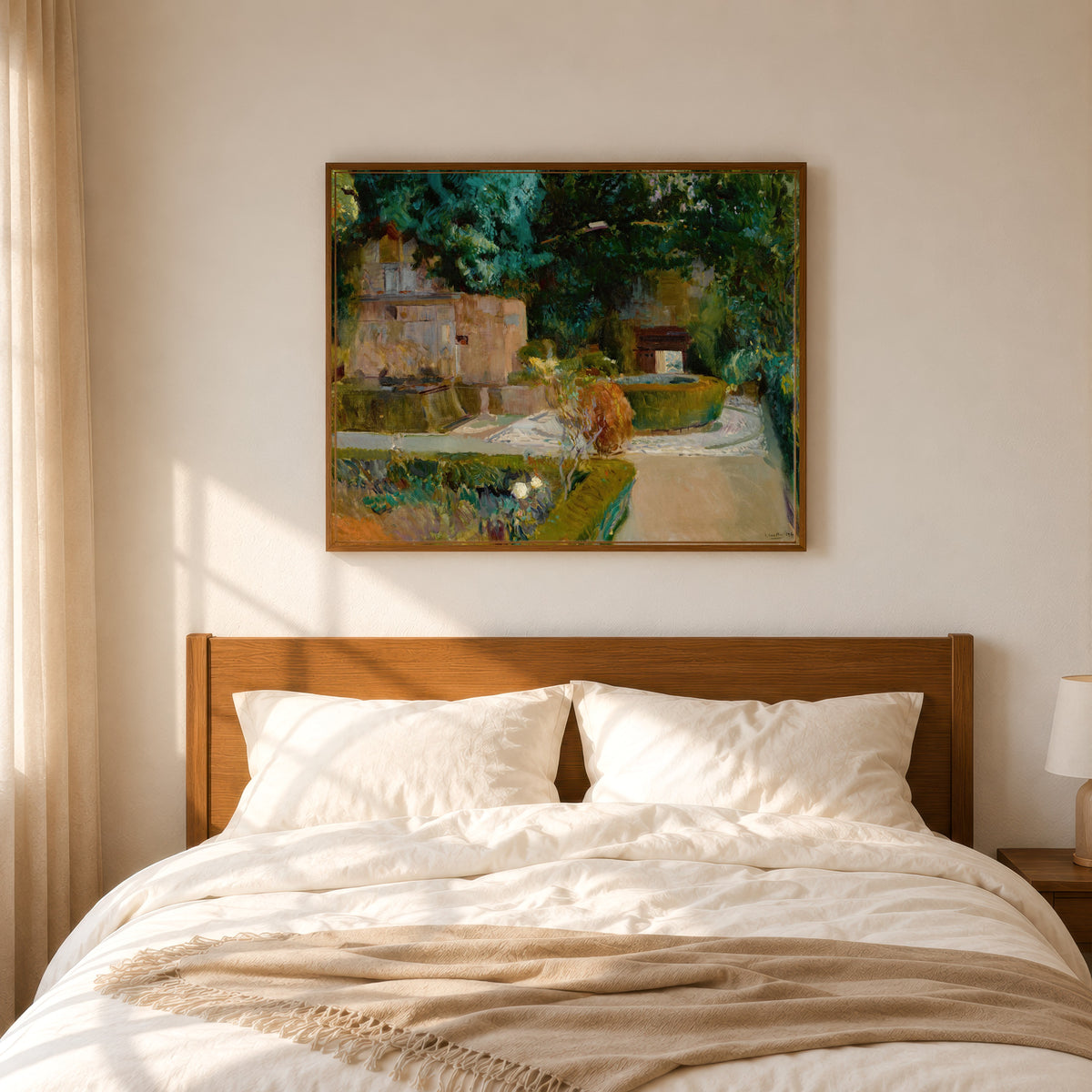 Framed art print of Garden of the Adarves, Alhambra, Granada by Joaquín Sorolla, in a slim wood frame above a bed in a sunlit bedroom