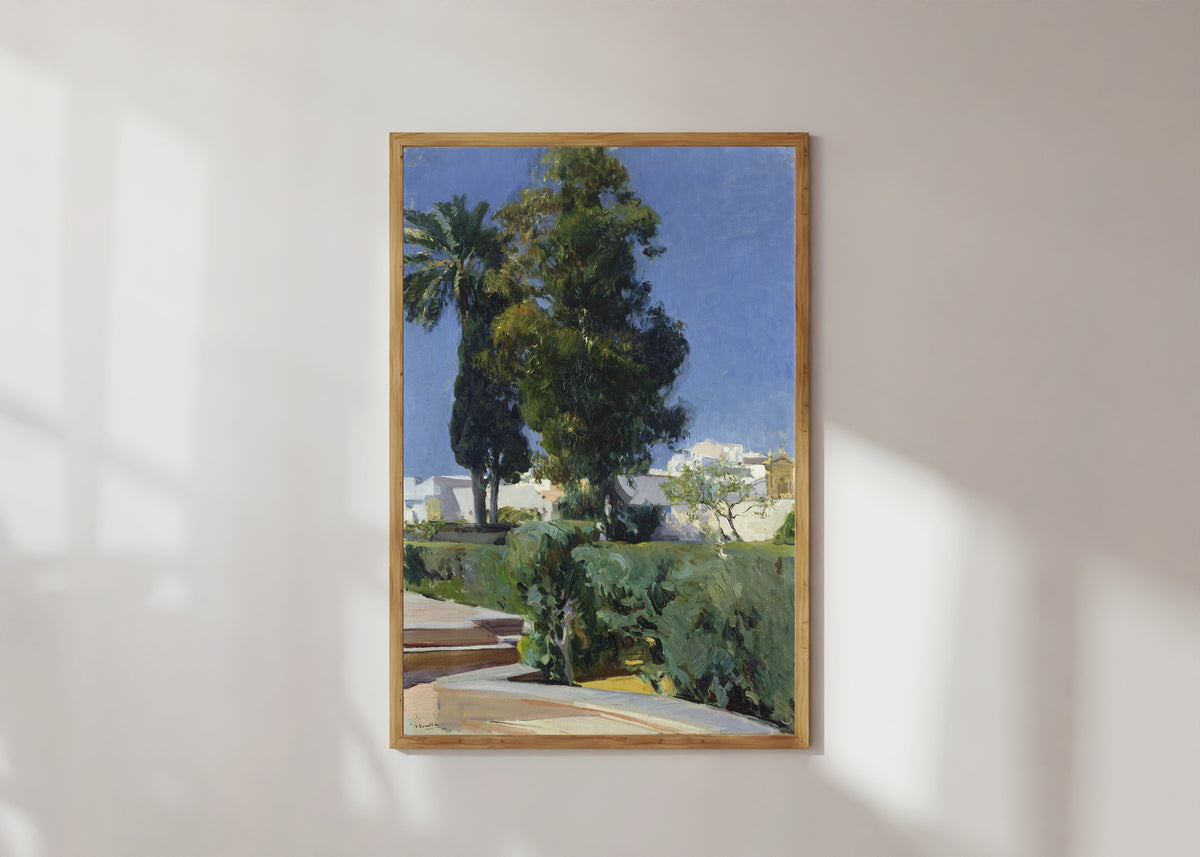 Framed art print of Gardens of the Alcázar, Seville by Joaquín Sorolla, in a light wood frame on a sunlit white wall