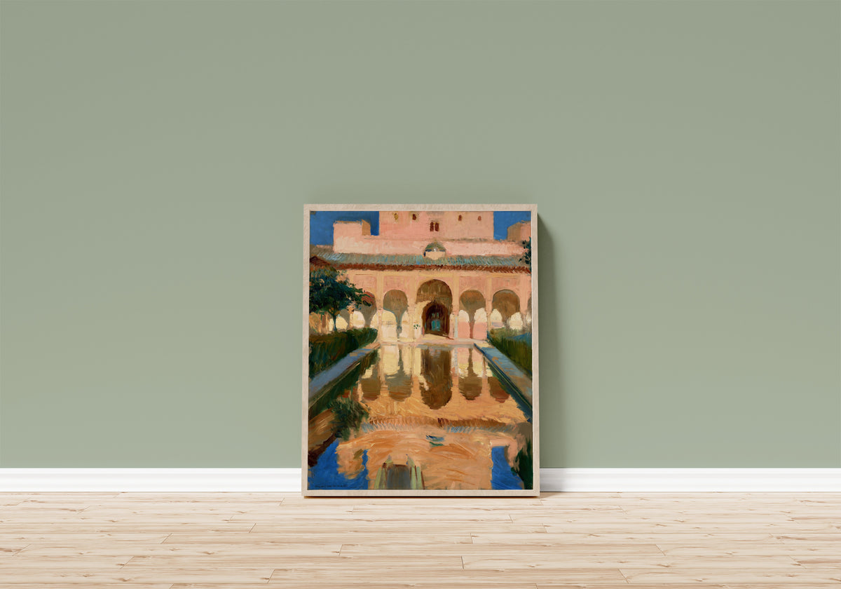 Framed art print of Hall of the Ambassadors, Alhambra, Granada by Joaquín Sorolla, in a light wood frame leaning on a sage green wall above a wooden floor