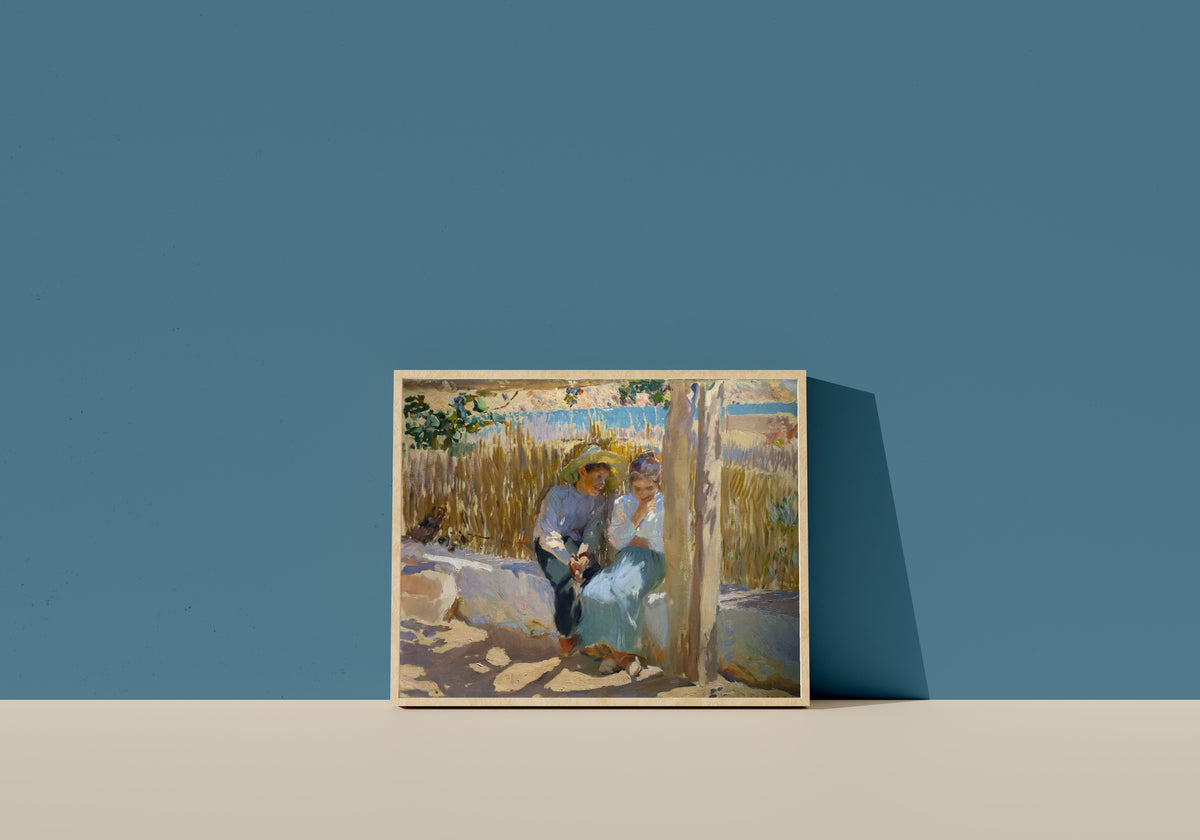 Framed art print of Idyll, Jávea by Joaquín Sorolla, in a light wood frame leaning on a blue wall