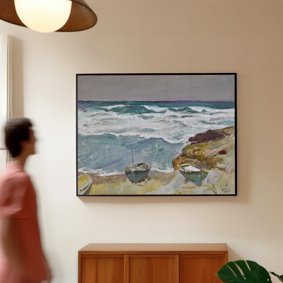 Framed art print of La Caleta Beach, Málaga by Joaquín Sorolla, in a slim black frame on a warm wall in a sunlit room