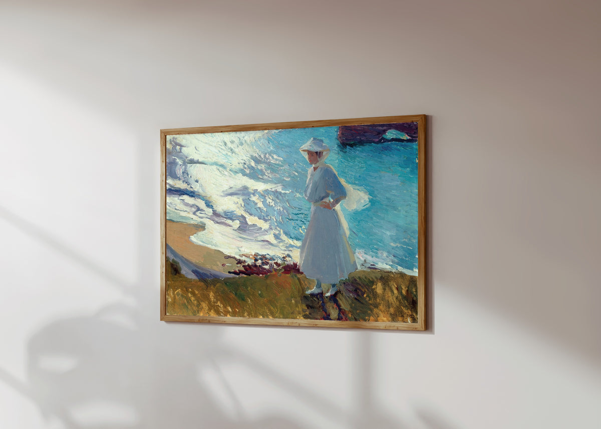 Framed art print of María on the Beach at Biarritz (Contre-jour) by Joaquín Sorolla, in a light wood frame on a sunlit white wall, seen at a slight angle