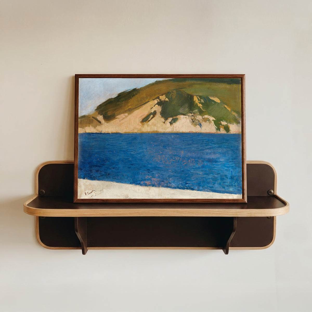 Framed art print of Monte Ulía, San Sebastián by Joaquín Sorolla, in a dark wood frame resting on a wall shelf