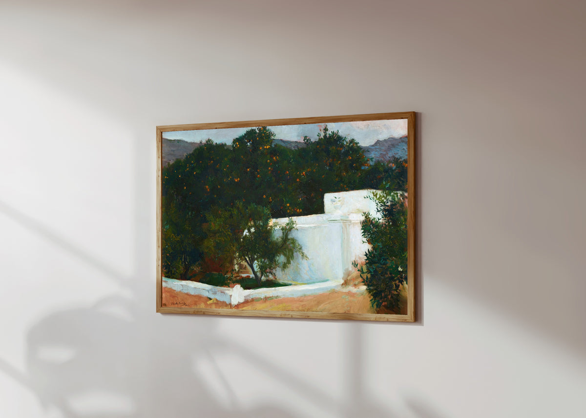 Framed art print of Orange Trees on the Road to the Sea, Valencia by Joaquín Sorolla, in a light wood frame on a sunlit white wall, seen at a slight angle