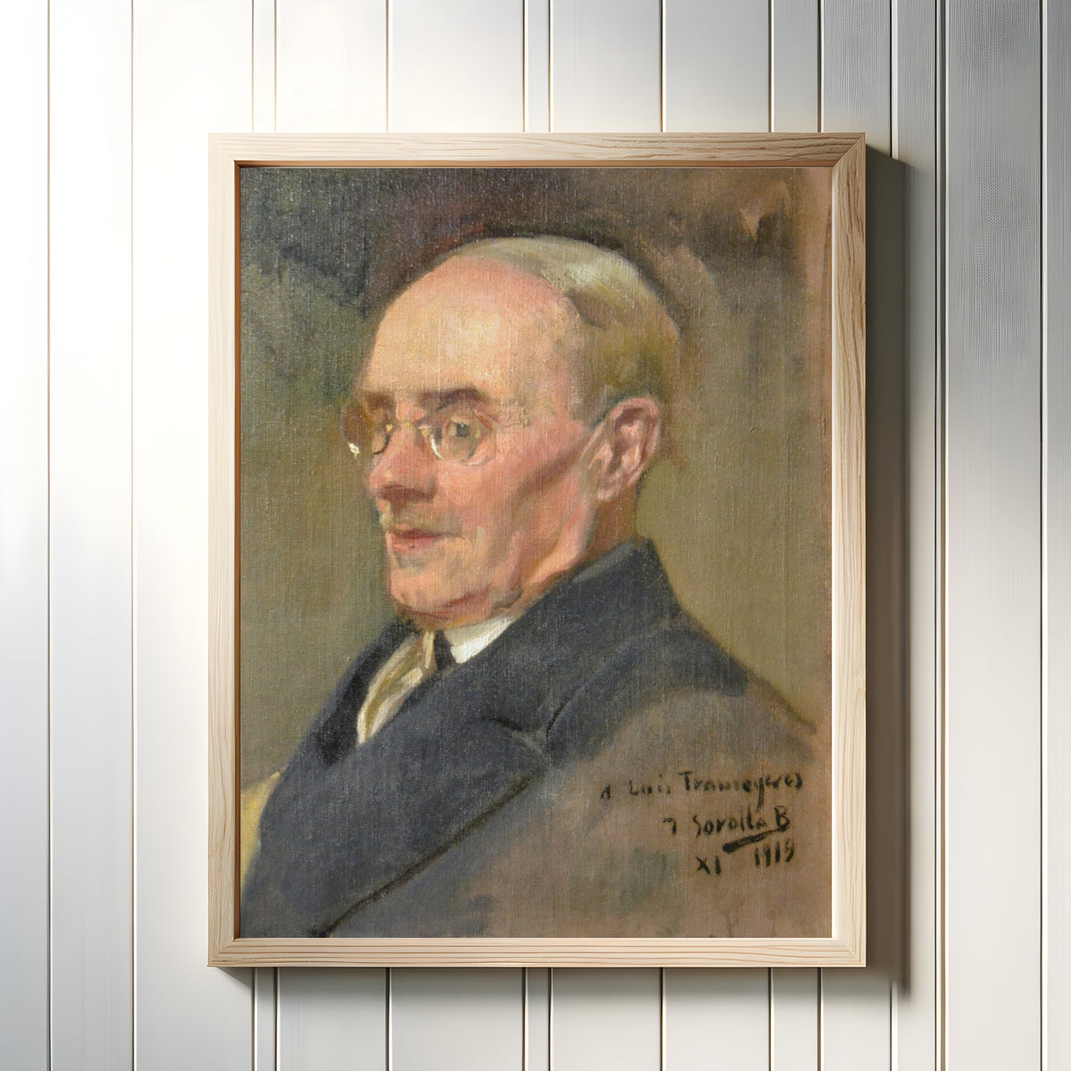 Framed art print of Portrait of Lluís Tramoyeres by Joaquín Sorolla, in a light wood frame on a white panelled wall