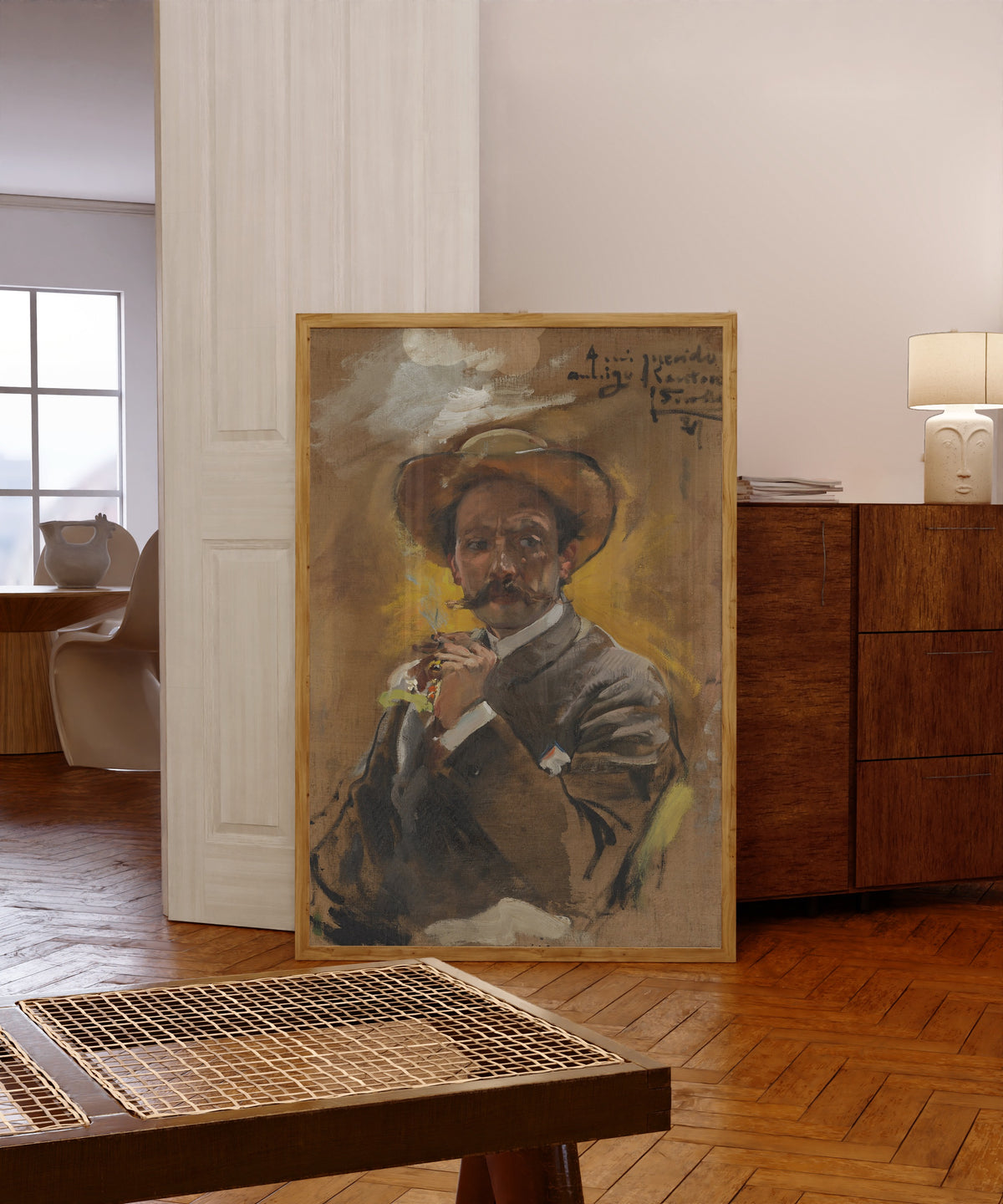 Framed art print of Portrait of the Painter Francesco Santoro, Rome by Joaquín Sorolla, in a light wood frame leaning in a warm room with a parquet floor