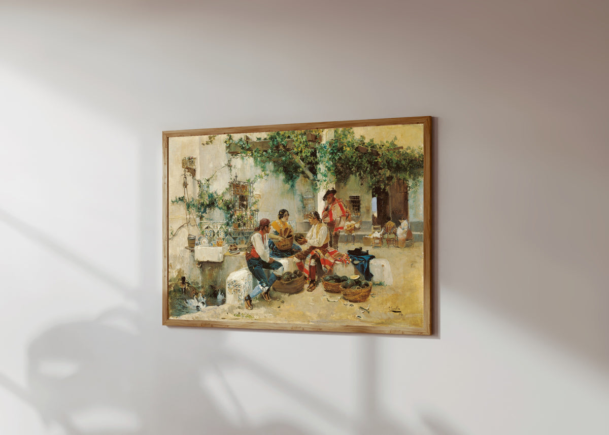 Framed art print of Selling Melons by Joaquín Sorolla, in a light wood frame on a sunlit white wall, seen at a slight angle