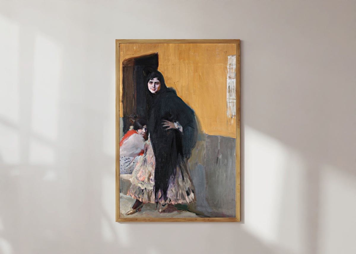 Framed art print of Sevillanas (Ladies of Seville) by Joaquín Sorolla, in a light wood frame on a sunlit white wall