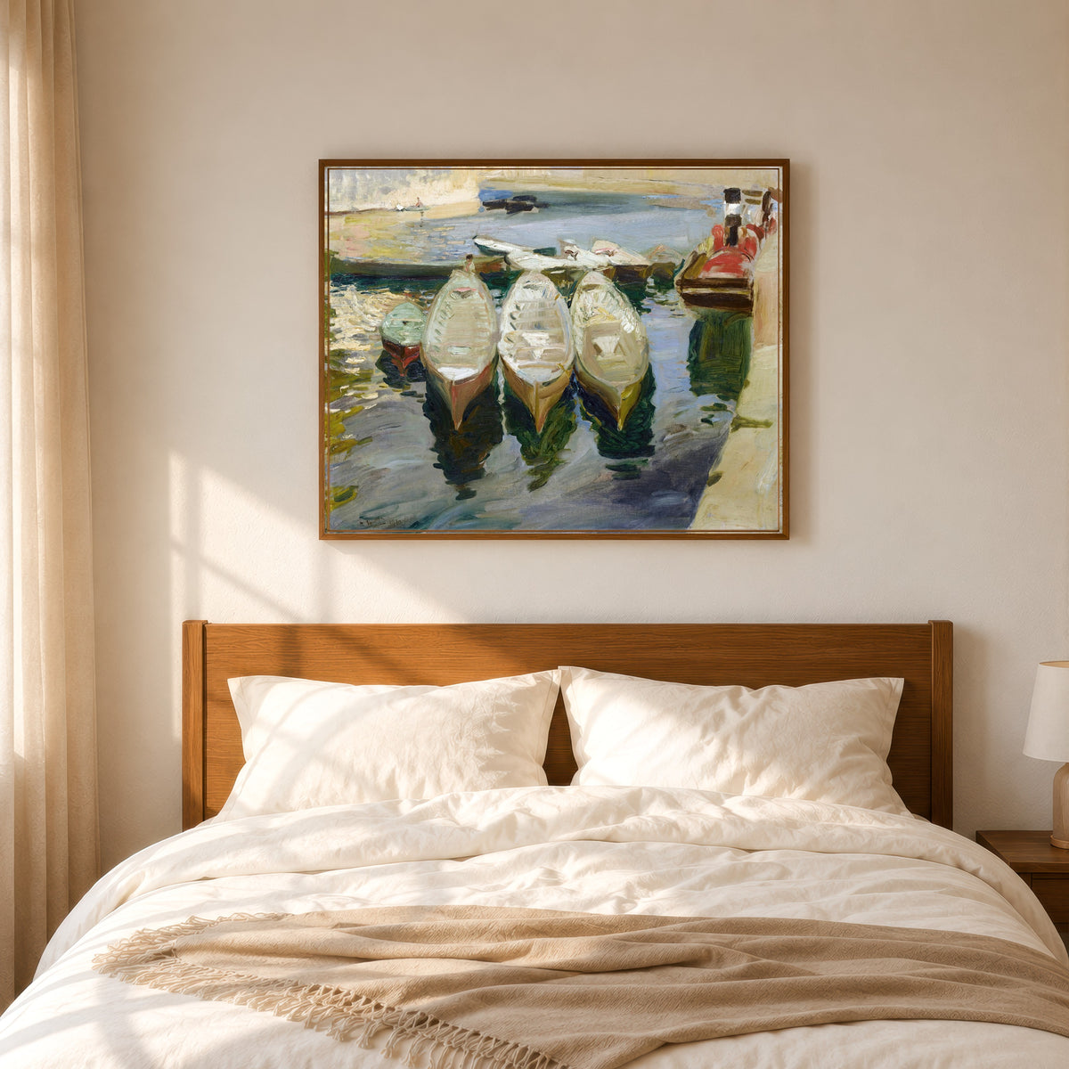 Framed art print of The Basque Port of Guetaria by Joaquín Sorolla, in a slim wood frame above a bed in a sunlit bedroom
