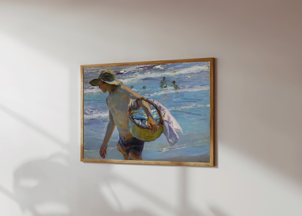 Framed art print of The Fisherman (El Pescador) by Joaquín Sorolla, in a light wood frame on a sunlit white wall, seen at a slight angle