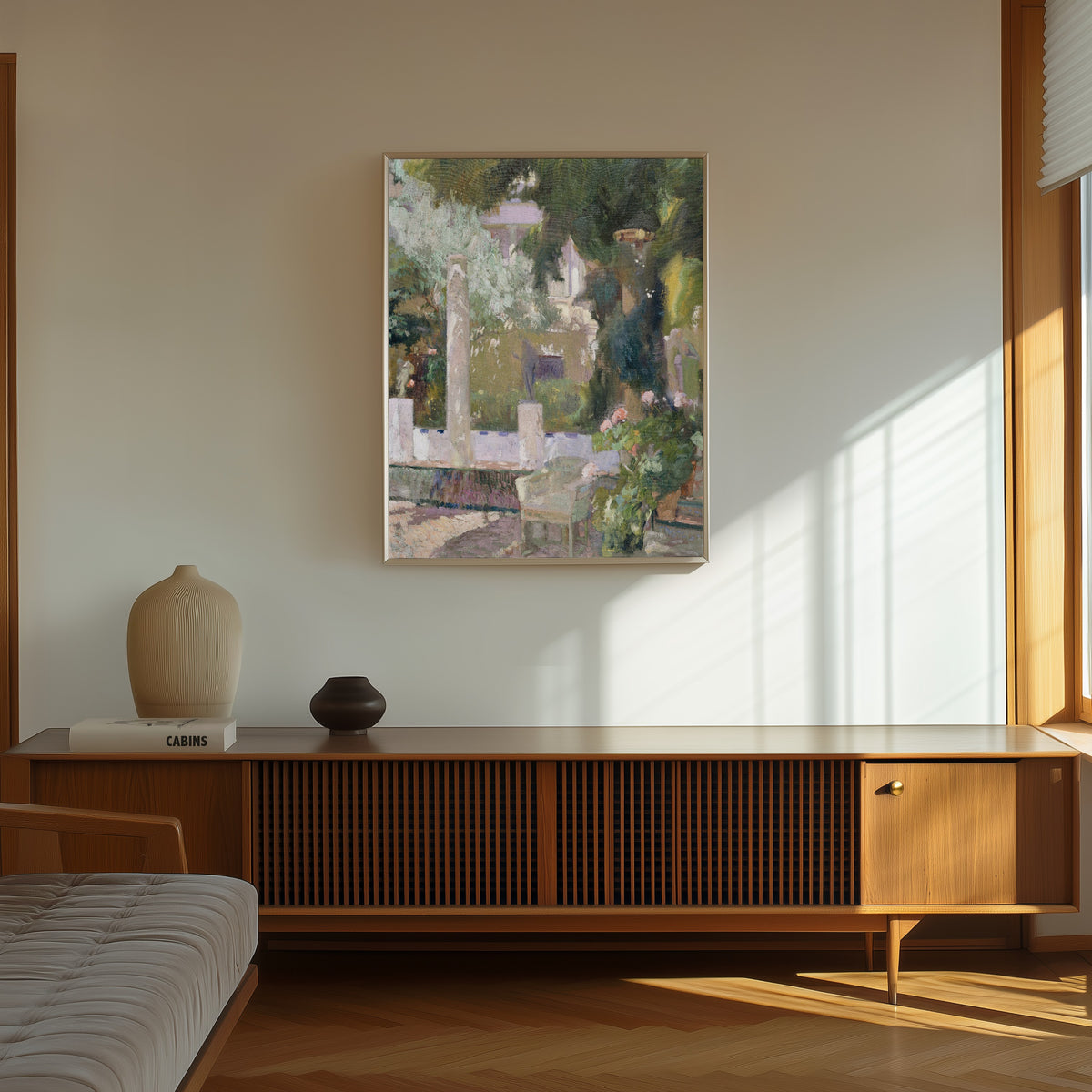 Framed art print of The Gardens at the Sorolla Family House by Joaquín Sorolla, in a thin light frame on a sunlit wall above a wooden sideboard
