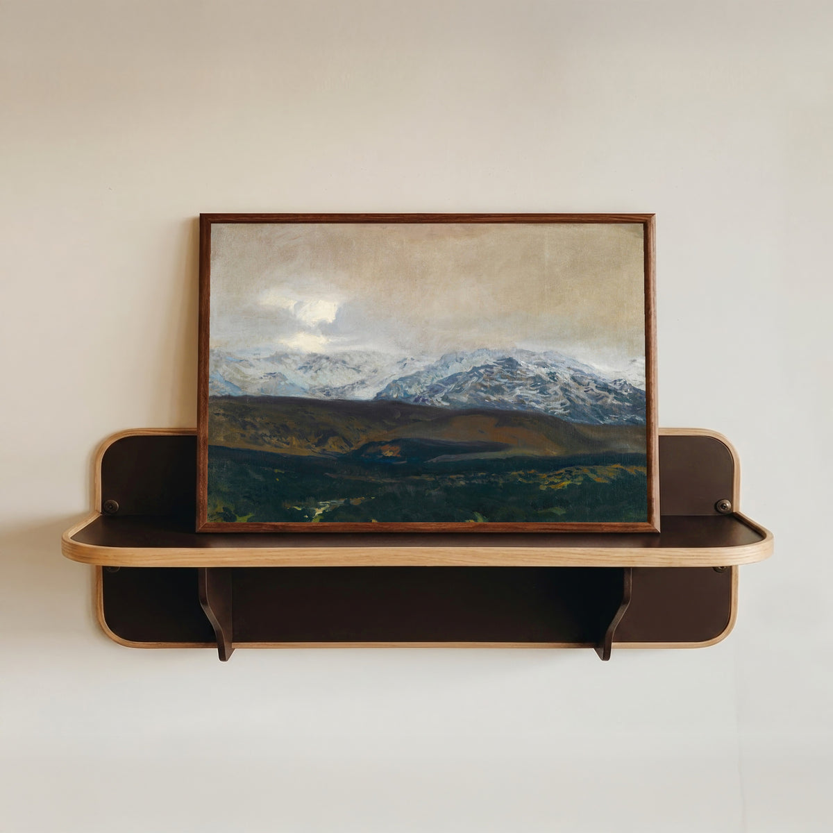Framed art print of The Sierra de Guadarrama by Joaquín Sorolla, in a dark wood frame resting on a wall shelf