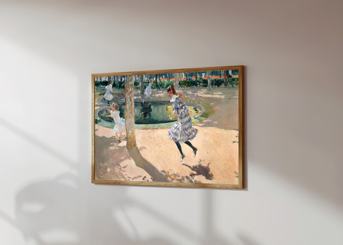 Framed art print of The Skipping Rope by Joaquín Sorolla, in a light wood frame on a sunlit white wall, seen at a slight angle