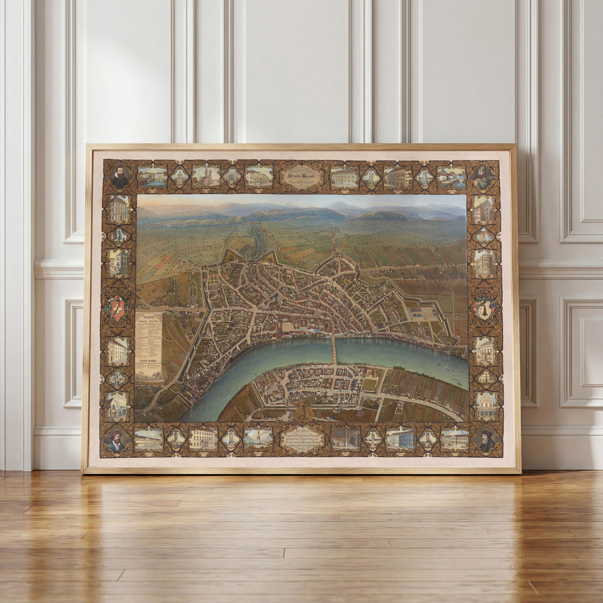 Framed art print of Malerischer Plan der Stadt Basel by Johann Friedrich Maehly, in a light wood frame leaning against a panelled white wall
