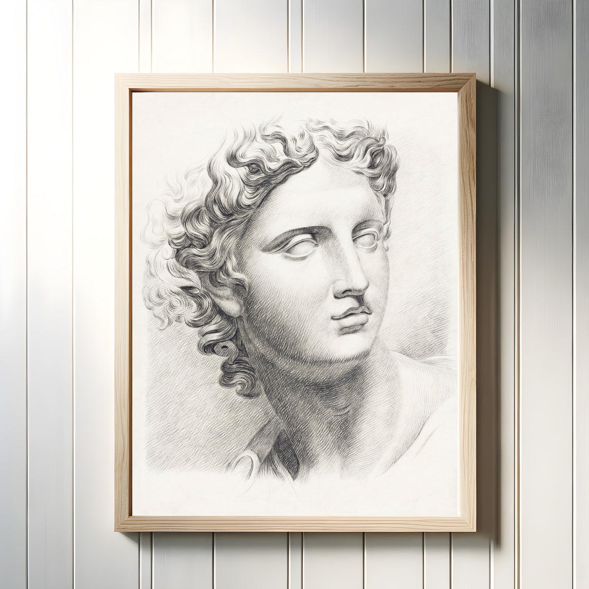 Framed art print of Man's Head by Johannes Tavenraat, in a light wood frame on a white panelled wall