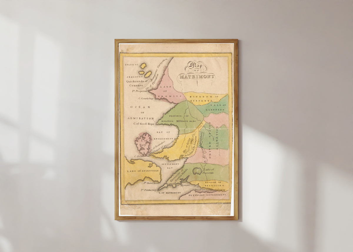 Framed art print of Map of Matrimony by John de Peyster Douw, in a light wood frame on a sunlit white wall
