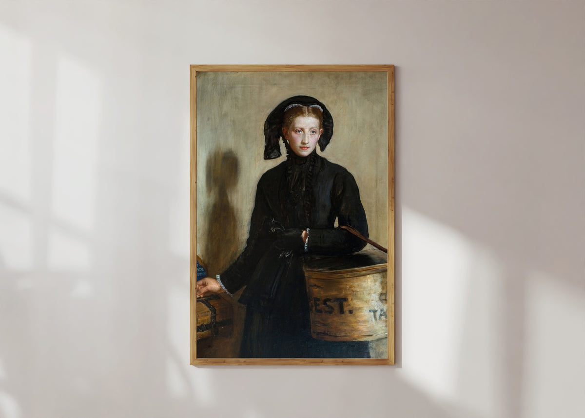 Framed art print of A Widow's Mite by John Everett Millais, in a light wood frame on a sunlit white wall