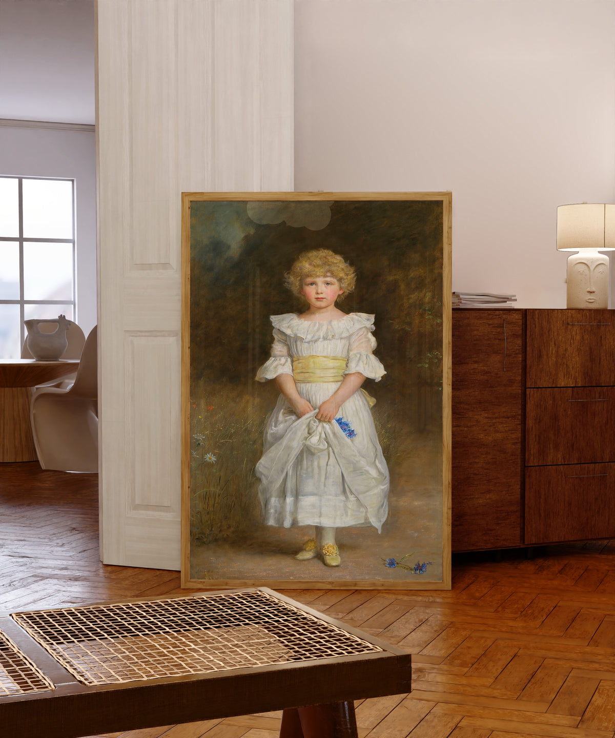 Framed art print of Portrait of Dorothy Lawson by John Everett Millais, in a light wood frame leaning in a warm room with a parquet floor