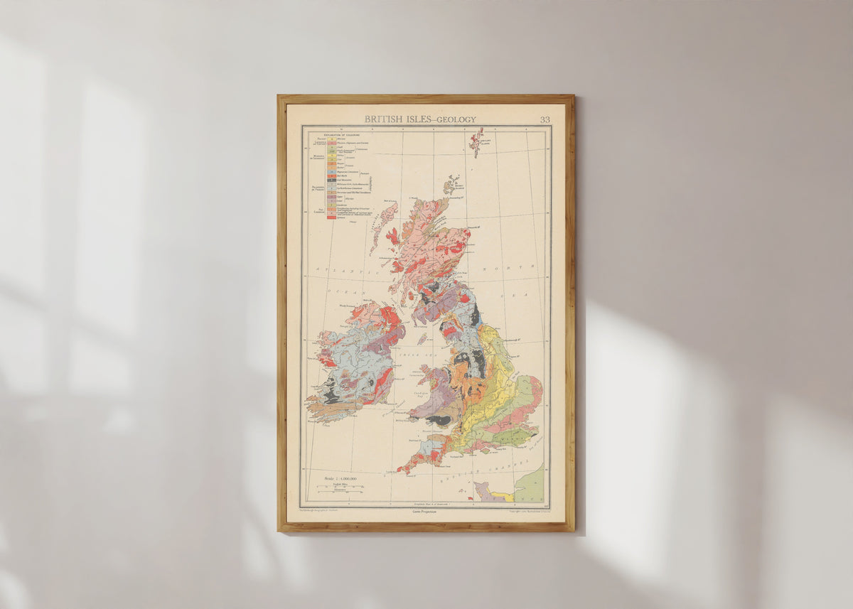 Framed art print of Geology (1942) by John George Bartholomew, in a light wood frame on a sunlit white wall