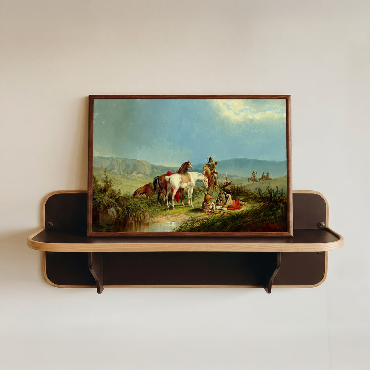 Framed art print of Indians Playing Cards by John Mix Stanley, in a dark wood frame resting on a wall shelf